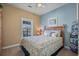 Cozy bedroom filled with natural light from the window and decorated with soothing colors at 5751 Oyster Catcher Dr. # 234, North Myrtle Beach, SC 29582