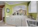 Bright kitchen showcasing a breakfast bar that opens to the living area, complemented by white countertops at 5751 Oyster Catcher Dr. # 234, North Myrtle Beach, SC 29582