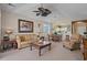Cozy living room featuring a ceiling fan, plush furnishings, and large windows for ample natural light at 5751 Oyster Catcher Dr. # 234, North Myrtle Beach, SC 29582