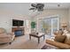 Comfortable living room with a fireplace, TV, balcony access and views into an adjacent bedroom at 5751 Oyster Catcher Dr. # 234, North Myrtle Beach, SC 29582
