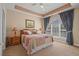 Inviting main bedroom featuring a decorative ceiling, large window, and plush bedding at 5751 Oyster Catcher Dr. # 234, North Myrtle Beach, SC 29582
