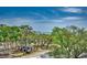Aerial view of a wooded area with RVs under lush trees and clear, blue sky with scattered clouds at 5905 S Kings Hwy. # A551, Myrtle Beach, SC 29575