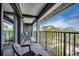 Relaxing balcony featuring chairs, a metal railing, and beautiful views of the green scenery at 5905 S Kings Hwy. # A551, Myrtle Beach, SC 29575