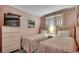 Well-lit bedroom featuring twin beds with wooden headboards, bedside table, and dresser at 5905 S Kings Hwy. # A551, Myrtle Beach, SC 29575