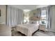Relaxing bedroom with wood flooring, soft lighting, comfortable bed and neutral decor at 5905 S Kings Hwy. # A551, Myrtle Beach, SC 29575