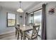 Dining room has hardwood floors, sliding glass door, and modern table and chairs at 5905 S Kings Hwy. # A551, Myrtle Beach, SC 29575