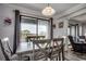 Well-lit dining area features a sliding glass door, table with chairs, and hardwood floors at 5905 S Kings Hwy. # A551, Myrtle Beach, SC 29575