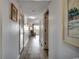Hallway features hardwood floors, white walls and a glimpse of a living room and balcony at 5905 S Kings Hwy. # A551, Myrtle Beach, SC 29575