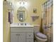 Well-maintained bathroom featuring a vanity with storage, an oval mirror, and a shower with a beach-themed curtain at 5905 South Kings Hwy. # 132-A, Myrtle Beach, SC 29575