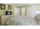 Comfortable bedroom with a queen-sized bed, TV, and easy access to an adjacent bathroom and closet space at 5905 South Kings Hwy. # 132-A, Myrtle Beach, SC 29575