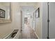 Hallway with wood-look flooring leads to a well-lit living area with a comfortable chair at 5905 South Kings Hwy. # 132-A, Myrtle Beach, SC 29575