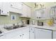 Well-lit kitchen with stainless steel sink and white cabinets, creating a bright and functional space for cooking and cleaning at 5905 South Kings Hwy. # 132-A, Myrtle Beach, SC 29575
