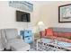 Comfortable living room with a gray armchair, patterned sofa, and nautical decor at 5905 South Kings Hwy. # 132-A, Myrtle Beach, SC 29575