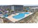 A large, private pool area with lounge chairs and a fence, located next to condo buildings at 5905 South Kings Hwy. # 132-A, Myrtle Beach, SC 29575