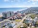 Aerial view of a coastal town with beachfront resorts, ocean views, and charming houses at 600 Hillside Dr. S, North Myrtle Beach, SC 29582