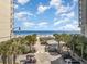 Stunning aerial view of the beach and ocean, lined with palm trees and a golf cart parking area at 600 Hillside Dr. S, North Myrtle Beach, SC 29582