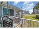 Cozy balcony seating area with views of the well-maintained grassy lawn and coastal buildings at 600 Hillside Dr. S, North Myrtle Beach, SC 29582