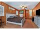 A cozy bedroom features wood-paneled walls, soft lighting, and comfortable furnishings at 600 Hillside Dr. S, North Myrtle Beach, SC 29582
