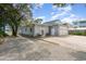 Charming home exterior with a wide driveway, garage, and rocking chairs on the porch at 600 Hillside Dr. S, North Myrtle Beach, SC 29582