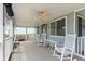 Inviting, covered front porch perfect for relaxation, with ample seating and a ceiling fan at 600 Hillside Dr. S, North Myrtle Beach, SC 29582