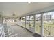 Relaxing screened-in front porch featuring comfortable seating and views of the neighborhood at 600 Hillside Dr. S, North Myrtle Beach, SC 29582