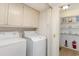 A functional laundry room with a washer and dryer, plus additional storage shelves at 600 Hillside Dr. S, North Myrtle Beach, SC 29582