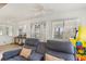 Sunlit living room featuring a comfortable blue couch with beach-themed pillows and view to the outdoors at 600 Hillside Dr. S, North Myrtle Beach, SC 29582