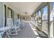 Inviting porch with white rocking chairs, perfect for relaxing and enjoying the neighborhood views at 600 Hillside Dr. S, North Myrtle Beach, SC 29582
