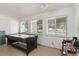 Spacious recreation room featuring an air hockey table and natural light from three windows at 600 Hillside Dr. S, North Myrtle Beach, SC 29582
