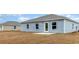 The backyard has light blue vinyl siding, good windows, and a small cement patio at 620 Culmen Ct., Myrtle Beach, SC 29588