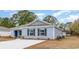 Cozy home with light blue siding, a new driveway, and manicured shrubs in the front at 620 Culmen Ct., Myrtle Beach, SC 29588
