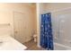 Bright bathroom featuring a vanity, toilet, and shower with a blue patterned curtain at 6207 Sweetwater Blvd. # 6207, Murrells Inlet, SC 29576