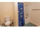 Bathroom featuring a toilet and tub shower with a decorative blue shower curtain at 6207 Sweetwater Blvd. # 6207, Murrells Inlet, SC 29576