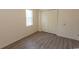 Empty bedroom featuring wood-look floors, a window, and a closet with folding doors at 6207 Sweetwater Blvd. # 6207, Murrells Inlet, SC 29576