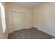 A neutral bedroom with wood-look floors, a closet, and a door, all bathed in soft, natural light at 6207 Sweetwater Blvd. # 6207, Murrells Inlet, SC 29576