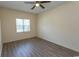 The bedroom is illuminated by a ceiling fan and natural light from the window at 6207 Sweetwater Blvd. # 6207, Murrells Inlet, SC 29576