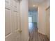 Hallway with wood floors leading to living room with ceiling fan and sliding glass doors at 6207 Sweetwater Blvd. # 6207, Murrells Inlet, SC 29576