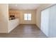 Living area featuring a kitchen counter passthrough and bright window with wood-look vinyl flooring at 6207 Sweetwater Blvd. # 6207, Murrells Inlet, SC 29576