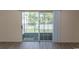 Sliding glass doors offer easy access to the patio from this living area with wood-look floors at 6207 Sweetwater Blvd. # 6207, Murrells Inlet, SC 29576