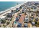 Aerial view of a charming beachside community with condos, houses and beautiful ocean views at 625 N Waccamaw Dr. # 301, Murrells Inlet, SC 29576