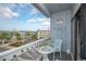 Balcony area with outdoor seating offering views of nearby buildings and tropical foliage at 625 N Waccamaw Dr. # 301, Murrells Inlet, SC 29576