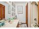 Bathroom showcasing double sinks, nautical art, and a bathtub with shower at 625 N Waccamaw Dr. # 301, Murrells Inlet, SC 29576