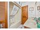Bathroom featuring double sinks, tub with shower, and nautical-themed decor at 625 N Waccamaw Dr. # 301, Murrells Inlet, SC 29576