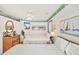 Cozy bedroom featuring two beds, nautical decor, and ample natural light at 625 N Waccamaw Dr. # 301, Murrells Inlet, SC 29576