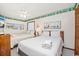 Comfortable bedroom with two beds, a ceiling fan, and nautical-themed decor at 625 N Waccamaw Dr. # 301, Murrells Inlet, SC 29576