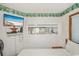 Bright bedroom with a TV, beach-themed decor, and a window view at 625 N Waccamaw Dr. # 301, Murrells Inlet, SC 29576