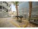 Outdoor community area featuring picnic tables, grills, and lush palm trees at 625 N Waccamaw Dr. # 301, Murrells Inlet, SC 29576