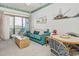 Comfortable living room with blue sofa, wicker coffee table, and sliding doors to balcony at 625 N Waccamaw Dr. # 301, Murrells Inlet, SC 29576
