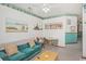 Cozy living room featuring a comfortable blue couch, ceiling fan, and nautical decor at 625 N Waccamaw Dr. # 301, Murrells Inlet, SC 29576