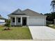 Charming single-story home with a two-car garage, well-manicured lawn, and inviting front porch at 643 Culmen Ct., Myrtle Beach, SC 29588